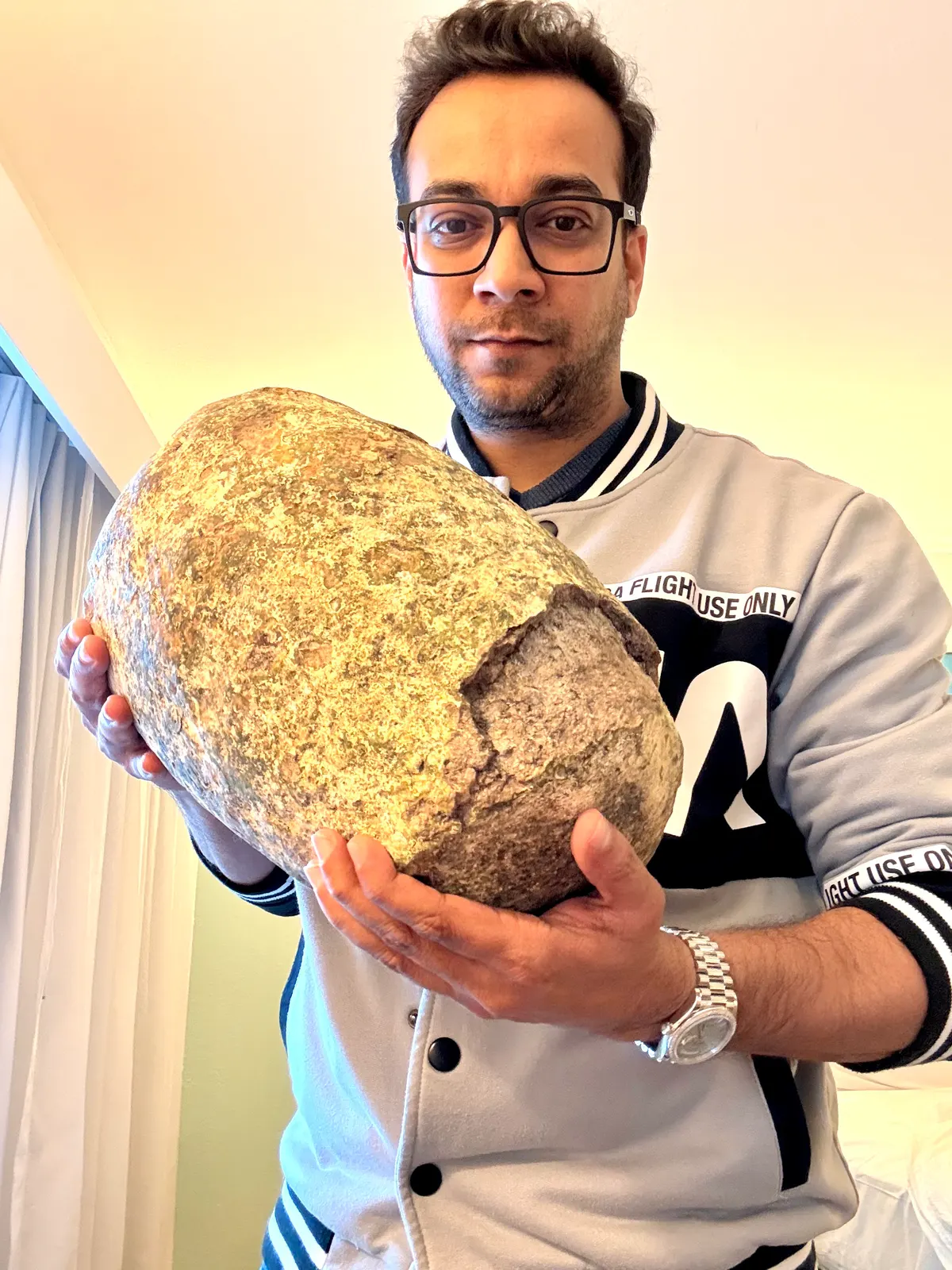 Large authentic ambergris specimen held by expert