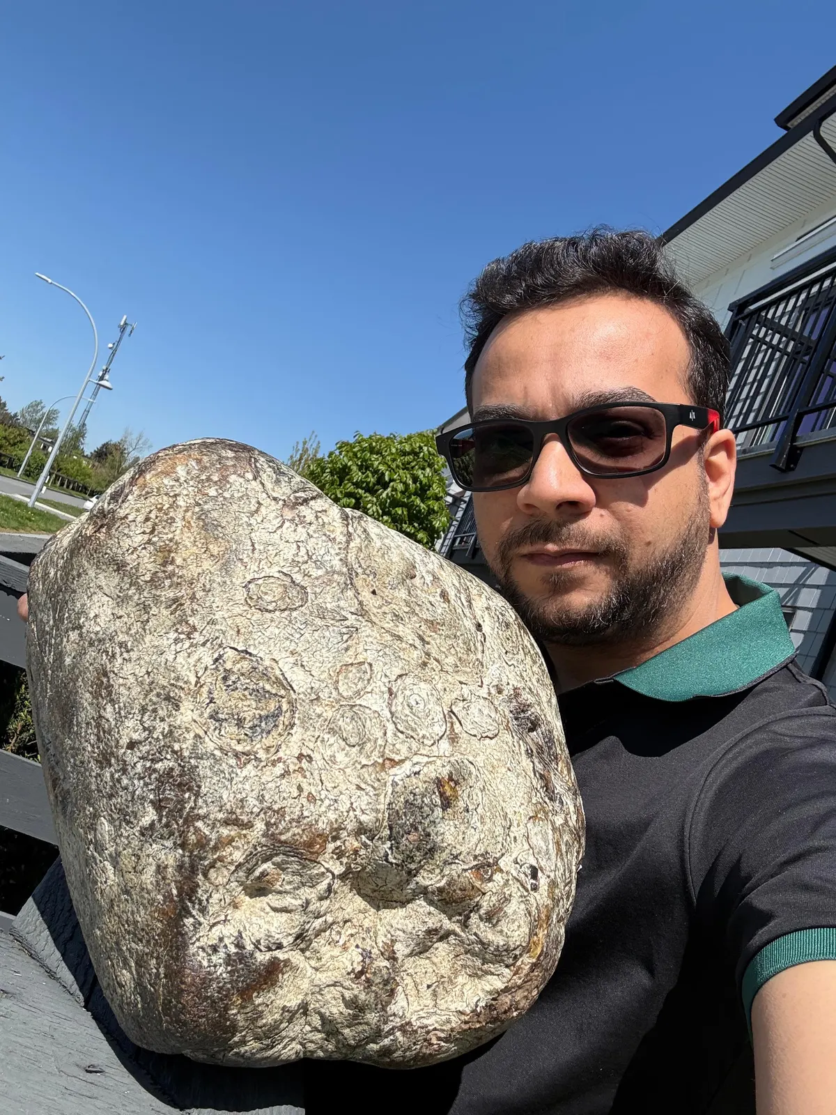 Large white ambergris specimen held outdoors by an Ambergris Canada expert