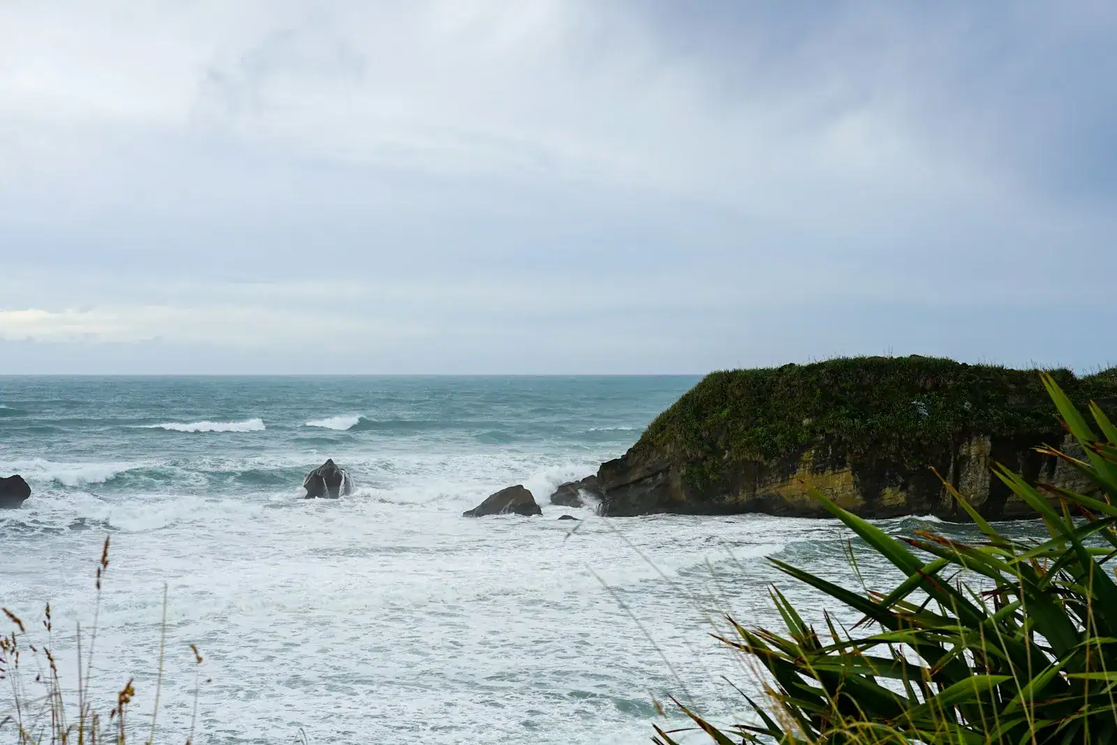 Rough sea breaking against a headland on the New Zealand west coast